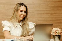 Personal injury case manager using laptop to manage client updates and treatment plans