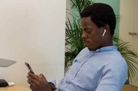 Client reviewing legal case updates on phone while working