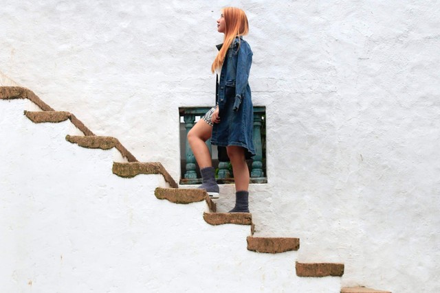 Woman ascending a staircase, symbolizing increased settlement amounts through client participation in personal injury cases