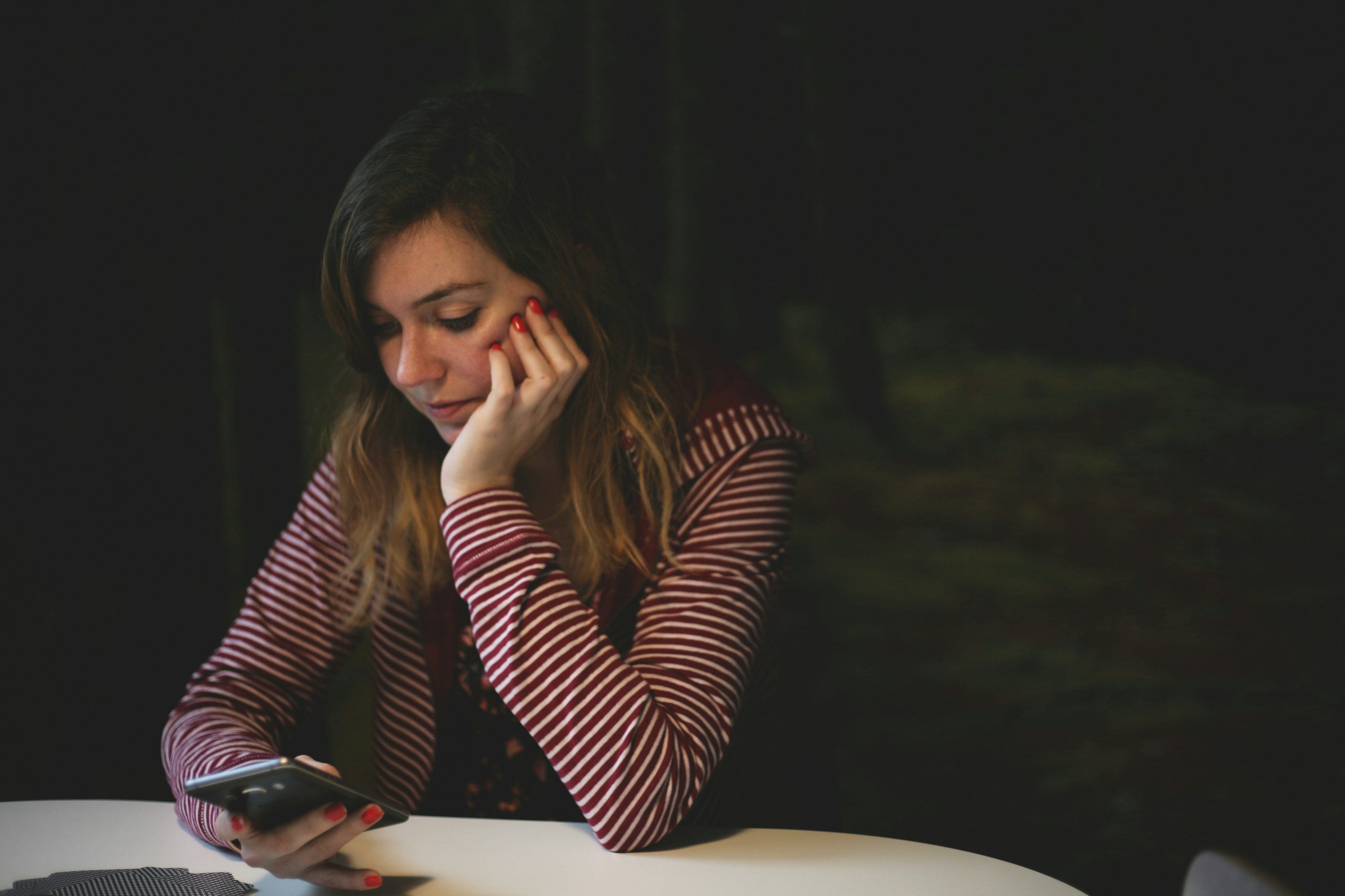 Woman using her cell phone to check the status of her car accident claim